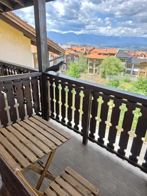 a wooden bench sitting on a balcony with a view at Balcony and Mountain View 7 min Walk to Ski Gondola in Bansko