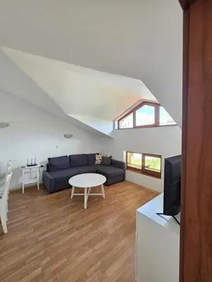 a living room with a couch and a table at Balcony and Mountain View 7 min Walk to Ski Gondola in Bansko