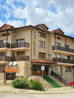 a large building with stairs in front of it at Balcony and Mountain View 7 min Walk to Ski Gondola in Bansko