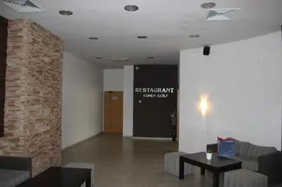 a living room with a brick pillar and a table at Comfort apartment in the house in Razlog