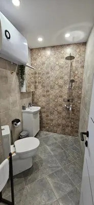 a bathroom with a toilet and a shower at By The Pool Apartments #10 in Velingrad