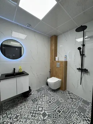 a bathroom with a toilet and a sink and a mirror at Plovdiv City Apartments in Plovdiv