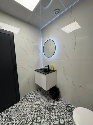 a bathroom with a sink and a mirror on a wall at Plovdiv City Apartments in Plovdiv