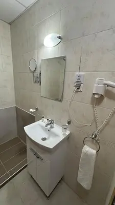 a bathroom with a sink and a shower with a mirror at Aspen Golf Resort Studio E206 in Bansko