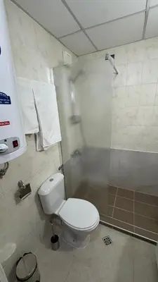 a bathroom with a white toilet and a shower at Aspen Golf Resort Studio E206 in Bansko