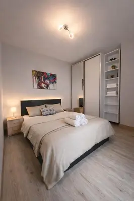 a bedroom with a large bed with towels on it at Mountain View Escape - Cozy Apt with Private Parking in Sofia