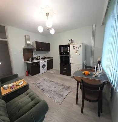 a living room with a couch and a table at ZAKKY STUDIO Cozy Apartment to the City Center and International Fair in Plovdiv