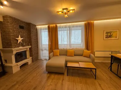 a living room with a couch and a fireplace at Pamporovo Living Cozy Mountain Home in Chepelare