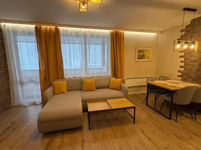 a living room with a couch and a table at Pamporovo Living Cozy Mountain Home in Chepelare