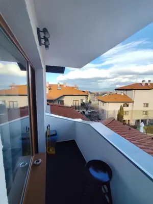 a balcony with a chair and a view of a city at Martin's Apartment in Bansko