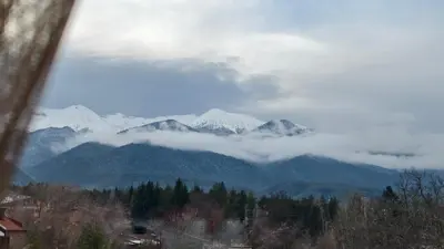 a view of a mountain range with snow covered mountains at Cozy Stylish 2-bedroom apt near ski road, 5min to Gondola & bars in Bansko