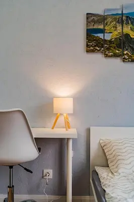 a desk with a lamp on it next to a bed at Central Apartment near NDK in Sofia