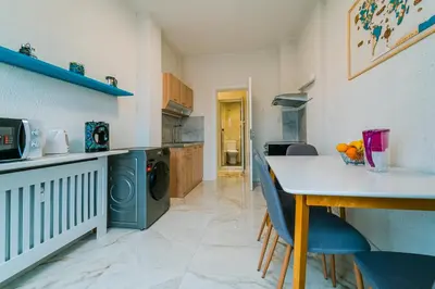 a kitchen with a table and chairs in a room at Central Apartment near NDK in Sofia