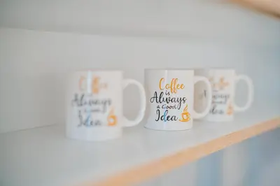 a row of coffee mugs on a shelf at Central Apartment near NDK in Sofia