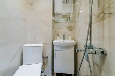 a bathroom with a toilet and a sink and a shower at Central Apartment near NDK in Sofia