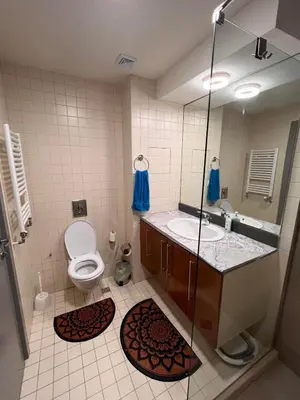 a bathroom with a toilet and a sink and a mirror at Lyra Forest Apartment in Borovets