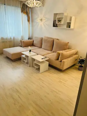 a living room with a couch and tables at Sofiaway Central Apartment in Sofia