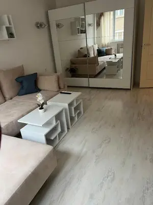 a living room with a couch and a large mirror at Sofiaway Central Apartment in Sofia