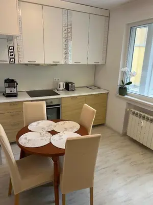 a kitchen with a table and chairs in a kitchen at Sofiaway Central Apartment in Sofia