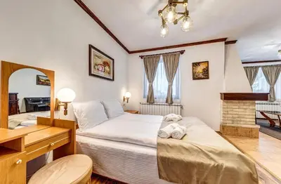 a bedroom with two beds and a desk at Комплекс Райковски Ливади in Pamporovo