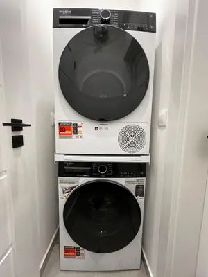 a microwave and a washing machine in a room at Monaco 100 Sq M 3BDR Apt on Oborishte street with WiFi in Sofia