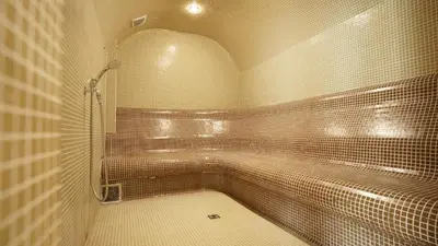 a tiled bathroom with a shower and a tub at Комплекс Белите скали in Gaytaninovo