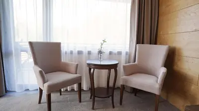 two chairs and a table in a room with a window at Комплекс Белите скали in Gaytaninovo