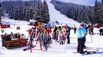 a group of people on skis in the snow at Edelweiss Mountain Apartment - Stream Resort Spa & Pool, Pamporovo in Pamporovo