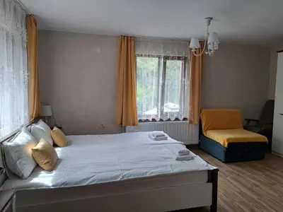 a bedroom with a large bed and a window at River Garden in Beli Osŭm