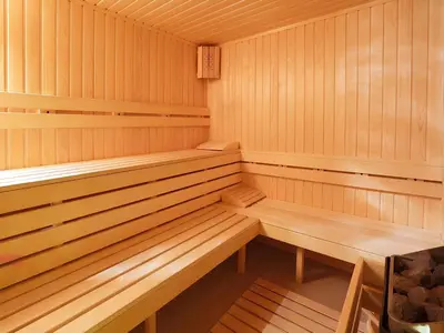 a wooden sauna with wooden benches in it at Private Studio in Royal Park in Bansko
