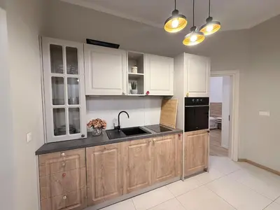 a kitchen with white cabinets and a sink at New top center cozy 3 bedroom apartment in Sofia