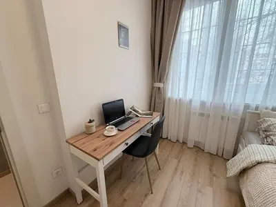 a desk with a laptop computer on it in a bedroom at New top center cozy 3 bedroom apartment in Sofia