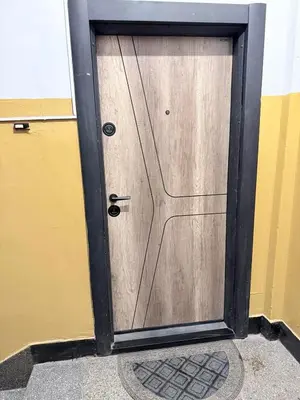 a metal door with a wooden at New top center cozy 3 bedroom apartment in Sofia