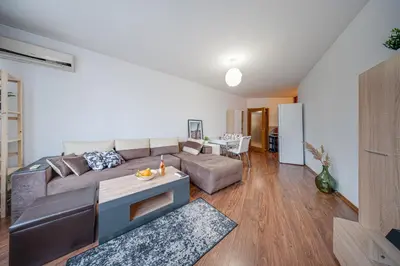 a living room with a couch and a table at Modern 1-Bedroom Apartment in Absolute City Center in Sofia