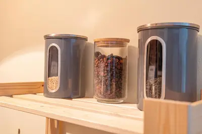 three containers of food sitting on a shelf at Modern 1-Bedroom Apartment in Absolute City Center in Sofia