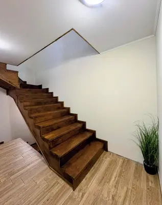 a staircase in a house with wooden floors at Стаи за гости Царвулджиеви in Koprivshtitsa