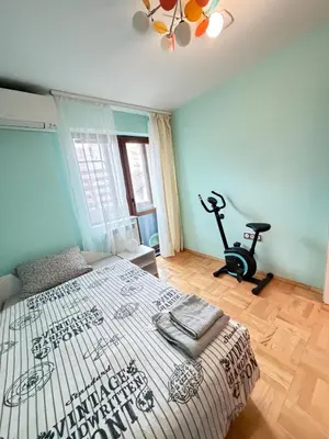 a bedroom with a bed and a exercise bike at New cozy 3 bedroom apartment 90m2 in Sofia