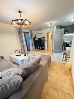 a living room with a couch and a table at New cozy 3 bedroom apartment 90m2 in Sofia