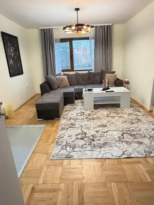 a living room with a couch and a table at New cozy 3 bedroom apartment 90m2 in Sofia