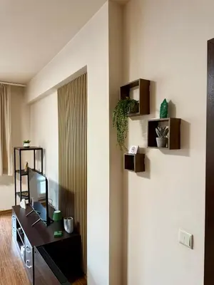 a living room with a tv on a wall at Gino's place Home2Host in Bansko