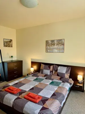 a bedroom with a bed with two pillows on it at Gino's place 2 Home2Host in Bansko