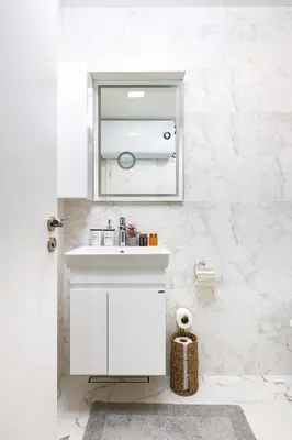 a white bathroom with a sink and a mirror at Gorgeous central Yanevi 2 BR & parking in Plovdiv