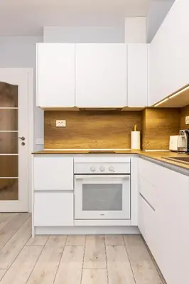 a kitchen with white cabinets and a white oven at Gorgeous central Yanevi 2 BR & parking in Plovdiv