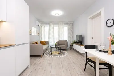 a living room with a couch and a table at Gorgeous central Yanevi 2 BR & parking in Plovdiv