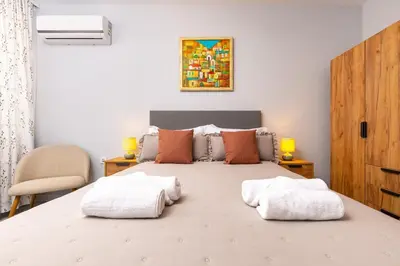a bedroom with a bed with two towels on it at Gorgeous central Yanevi 2 BR & parking in Plovdiv