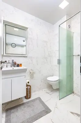 a bathroom with a glass shower and a toilet at Gorgeous central Yanevi 2 BR & parking in Plovdiv