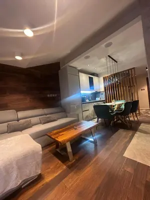 a living room with a couch and a table at Prime Mountain View Bansko in Bansko