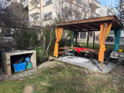 a picnic shelter with a table and a fireplace at Berta Gardens 1 in Sandanski