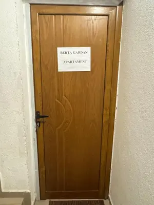 a sign on a wooden door with a sign on it at Berta Gardens 1 in Sandanski