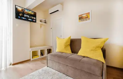 a living room with a couch with yellow pillows at 2BR Apt - Parking - Central - 1st floor - ACs in Sofia